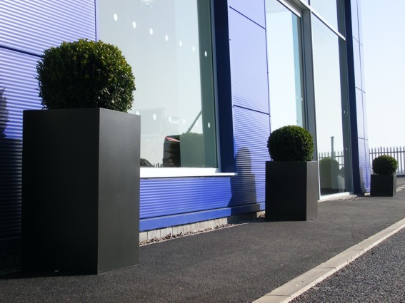 stone look exterior planters with buxus